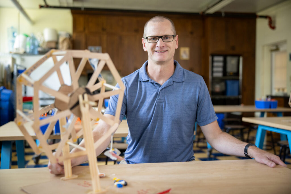 Catholic middle school science teacher David Heintz with a STEM structure