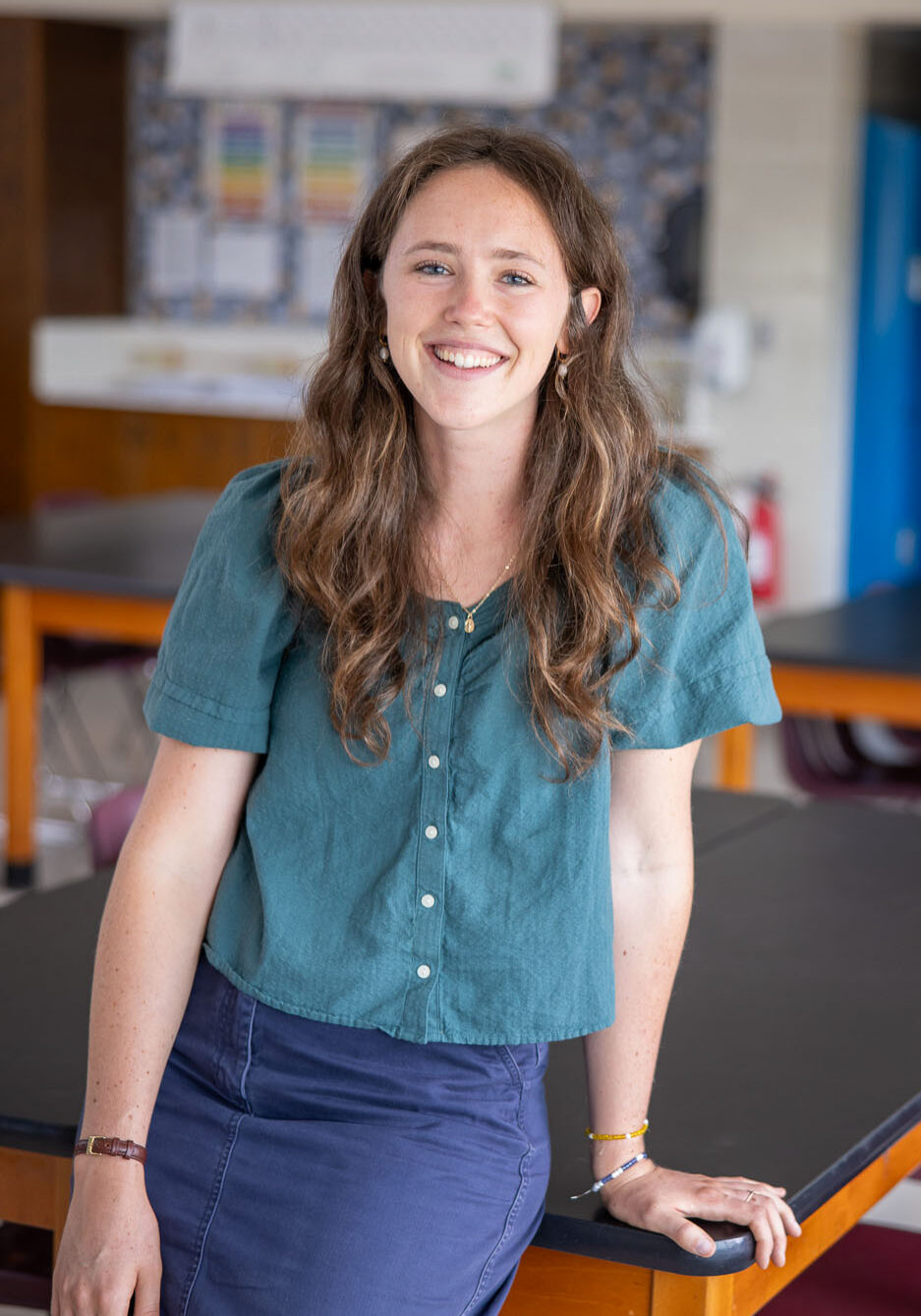 Smiling female Catholic school teacher in classroom